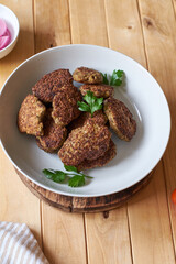 rissole on a wooden background decorated with sage.