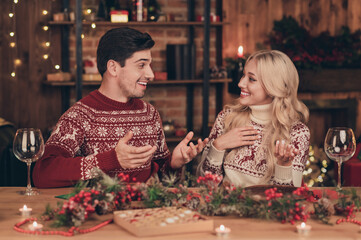 Photo of funky couple drink alcohol say wear red jumpers on new year indoors