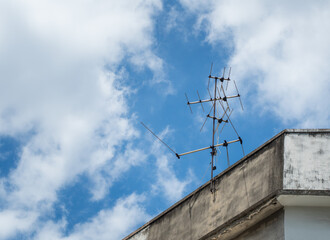 Old TV antenna installed on urban house. Communication device image.