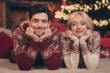 Photo of adorable thoughtful husband wife dressed print pullovers making noel wishes closed eyes...