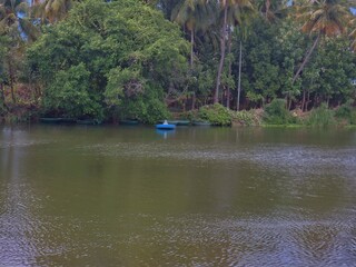In the distance a person drives the boat...