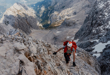 Man climbing steep rock mountain