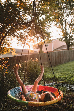 Swinging on her tree swing at sunset