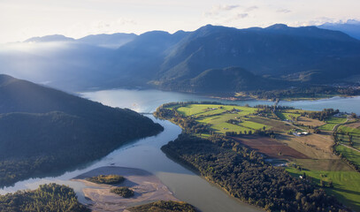 Aerial View of Fraser Valley with Canadian Nature Mountain Landscape Background. Harrison Mills near Chilliwack, British Columbia, Canada. - obrazy, fototapety, plakaty