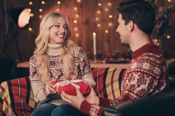 Photo of pretty charming husband wife wear print sweater smiling celebrating noel getting present indoors house home room