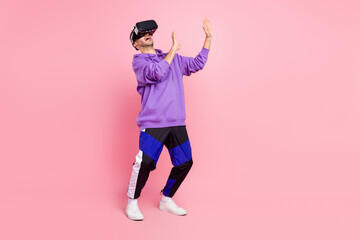 Fototapeta na wymiar Full length photo of young guy virtual reality modern technology touching isolated over pink color background