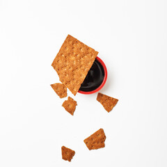 Minimalism. Red cup of coffee or tea among fresh healthy rusks