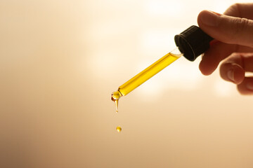 Closeup of a pipette with organic facial oil.