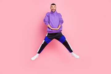 Fototapeta na wymiar Full body photo of young excited man have fun fly jumper sporty cool isolated over pink color background
