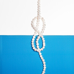 Flat lay. Top view. Fashion and beauty. Pearl necklace