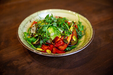 Healthy vegetable salad of fresh tomato, cucumber, onion, spinach, lettuce and sesame on plate. Diet menu.