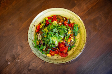 Healthy vegetable salad of fresh tomato, cucumber, onion, spinach, lettuce and sesame on plate. Diet menu.