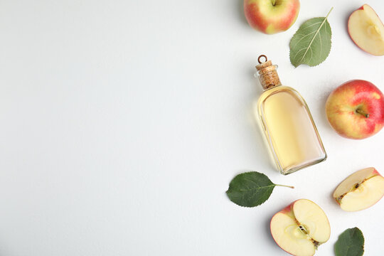 Natural Apple Vinegar And Fresh Fruits On White Background, Top View. Space For Text