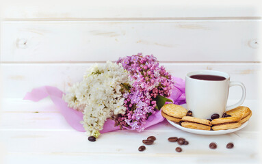 Bouquet of Purple and White Lilac with Cup of Coffee and Biscuits on  Wooden Background 