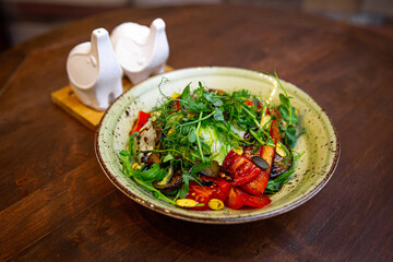 Healthy vegetable salad of fresh tomato, cucumber, onion, spinach, lettuce and sesame on plate. Diet menu.