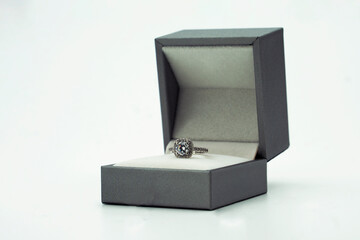 Diamond ring in jewelry gift box on white background