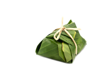Green banana leaf wrap food for carrying. Thai and Asian stye dessert package isolated on white...