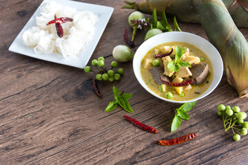 Chicken green curry with bamboo shoots and blood pudding (Kaeng kheiyw hwan) on dark wooden background with Thai tradition food served with steamed rice. Thai food very popular