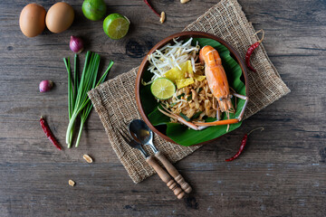 Pad Thai with fresh shrimp on a wooden table Pad Thai is a delicious Thai street food. And popular people around the world - 462468715