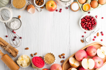 Ingredients for autumn winter baking - flour, sugar, eggs, apples, pumpkins and spices.