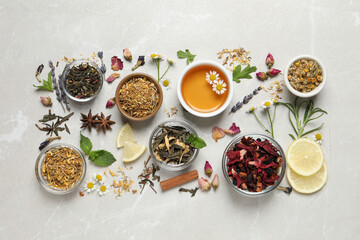 Flat lay composition with fresh brewed tea and dry leaves on light table