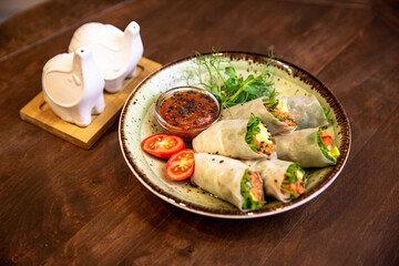 Healthy vegetable salad of fresh tomato, cucumber, onion, spinach, lettuce and sesame on plate. Diet menu.