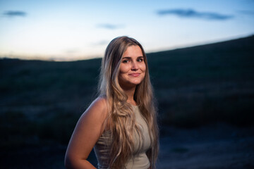 Portrait of a blonde caucasian woman smiling while gets dark