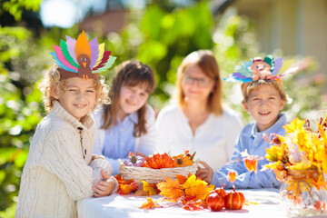Family celebrating Thanksgiving. Kids crafts.