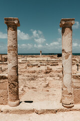 Panoramic opening to the sea landscape, closed with columns. Tombs of the Kings, Cyprus. A beautiful sunny summer day. Visiting the archaeological monuments.