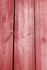 Wall made of uncutted weathered wood boards in red color.