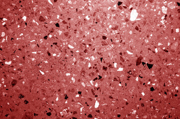 Cement plate with small gravel stones in red tone.