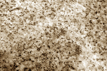 Granite surface as background with blur effect in brown tone.