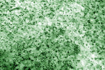 Granite surface as background with blur effect in green tone.