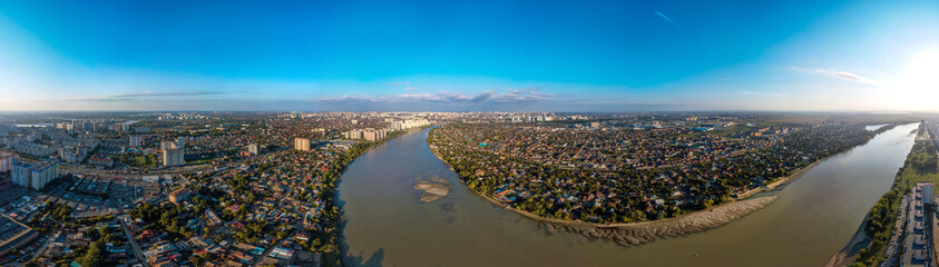A large aerial panorama of the shallow Kuban River near the Yubileiny microdistrict of the city of Krasnodar and the village of Novaya Adygea (South of Russia) on a sunny day in mid-autumn. - obrazy, fototapety, plakaty