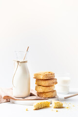 Freshly baked homemade honey cookies with milk for breakfast on a white background