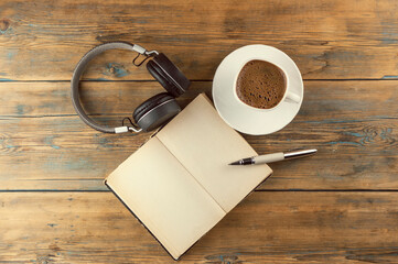 Open a blank page book, pen and cup of coffee on the desk