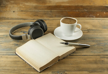 Open a blank page book, pen and cup of coffee on the desk