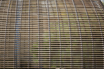 The texture of the weave of twigs of wood as a craft. The manufacture of household items.