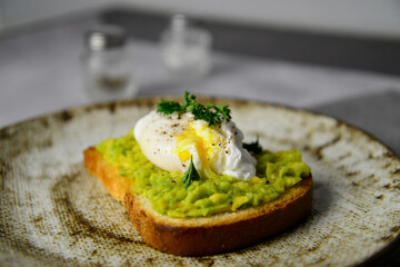 The burger with avocada and poached egg for healthy breakfast.