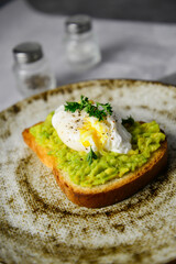  The burger with poached egg and avocado for breakfast. Healthy food.