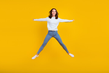 Fototapeta na wymiar Full body photo of cheerful happy young woman jump up good mood active sale isolated on yellow color background