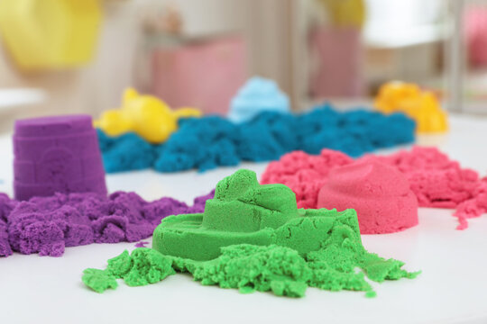 Colorful Kinetic Sand On White Table Indoors