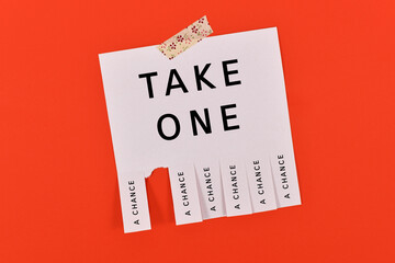 Tear-off stub note with text 'Take a chance' on red background