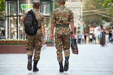 two soldiers walking in street