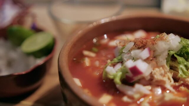 Clay bowl of delicious and traditional Mexican pozole