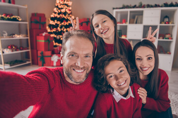 Photo of cheerful family have fun spend holiday together shoot selfie record video decoration guy indoors