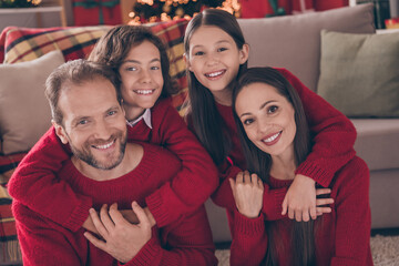 Photo of cheerful husband and wife with kids prepare x-mas party dream cuddle jolly holly winter indoors