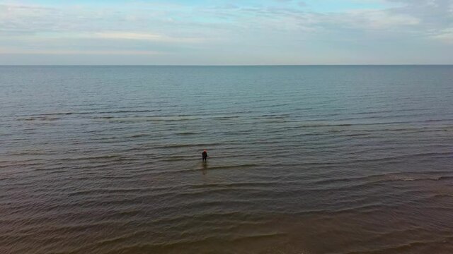 Fisherman Catches Flounder in the Kolka Cape, Baltic Sea, Latvia. Aerial View During Autumn Evening Sunset. Kolka Horn Divides Baltic Sea and Riga Bay.