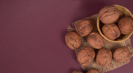 closeup photo of a walnut seed in wooden bowl. Food that is good for brain and lower risk of heart disease.