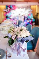 Beautiful flowers on table in restaurant. Birthday party. Elegant interior. Selective focus 